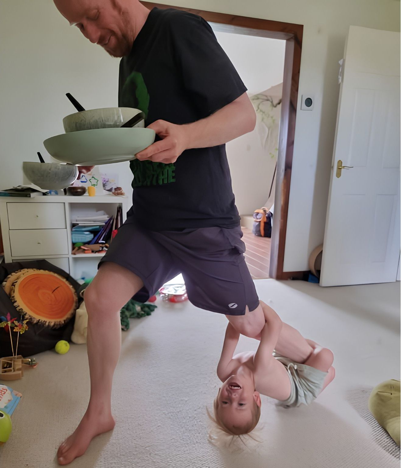 Bjorn in a lunge with his son on his leg